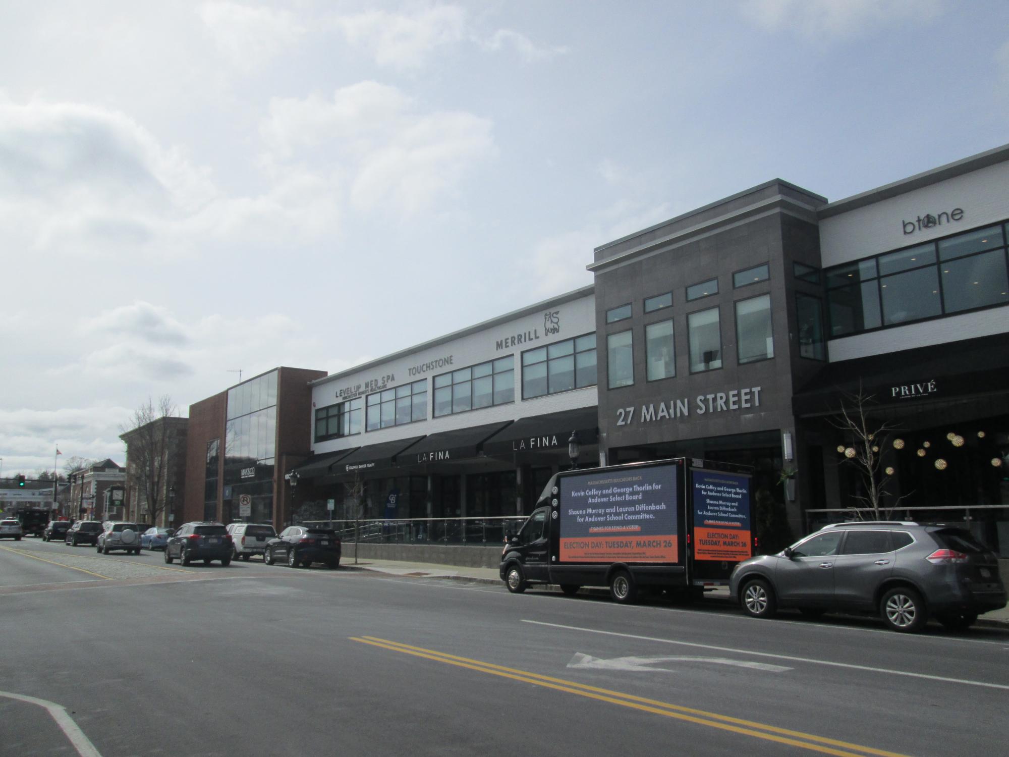 LED mobile billboard stopped along Main Street in Andover MA, displaying a political ad supporting candidates for Select Board and School Committee.